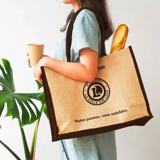 Woman holding  jute bag or sack bag on white background. Reusable shopping bag. Natural material. Zero waste. Plastic free. Eco friendly concept.