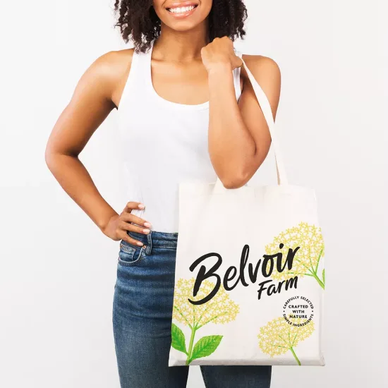 Ecology Concept. Unrecognizable african woman with tote bag over isolated white studio background. Mockup, free space
