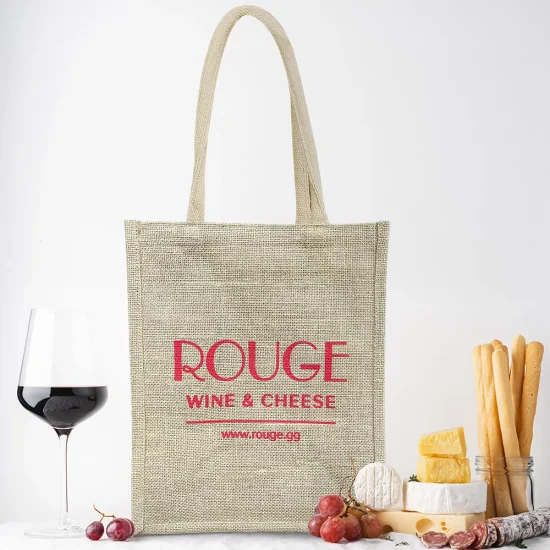 Glass of red wine and cheese, sausage, grapes and grissini bread sticks on the table. Light background, traditional wine snacks on tablecloth covered table